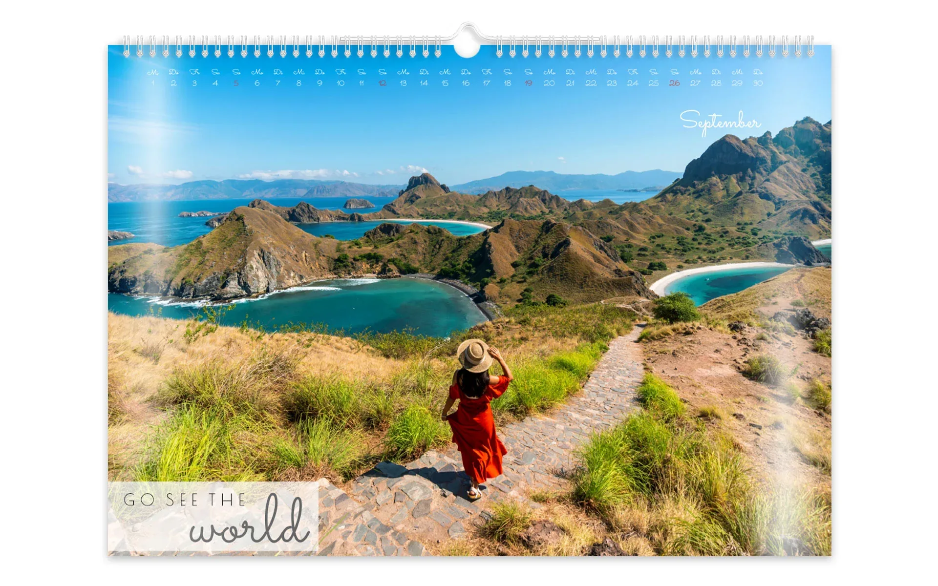 HappyFotokalender ca. A3 quer Ein HappyFotokalender ca. A3 quer mit dem Text Go see the world zeigt ein vollflächiges Foto einer Frau in der Natur.