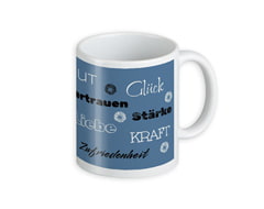 Tasse mit inspirierenden Wörtern wie Glück, Kraft, Liebe und Vertrauen auf blauem Hintergrund.