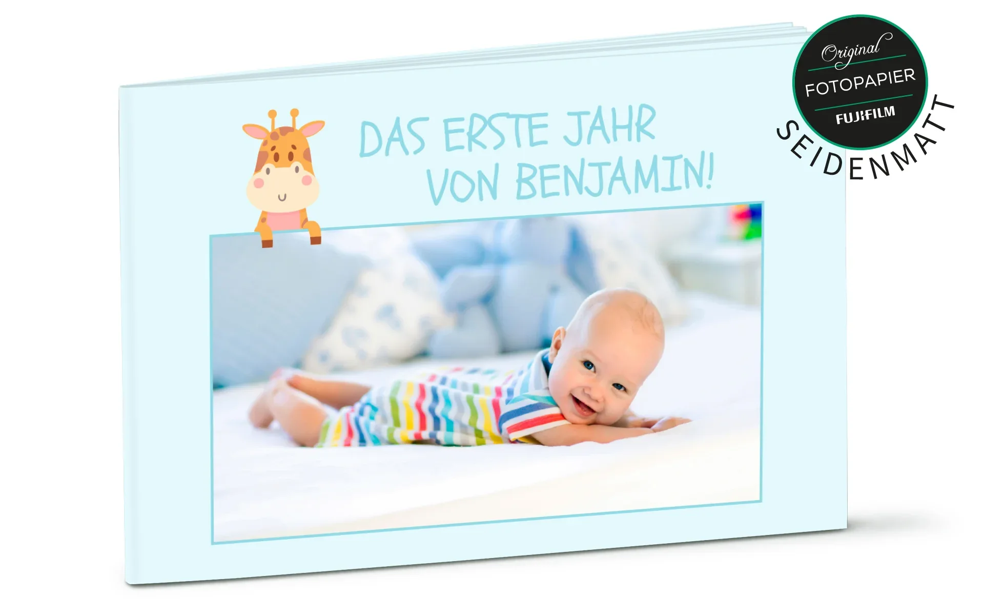 Happy Fotobuch ca. 10 x 15 cm Ein aufgestelltes Happy Fotobuch ca. A4 hoch mit dem Titel Das erste Jahr von Benjamin zeigt ein Baby und ein Giraffen-Clipart.