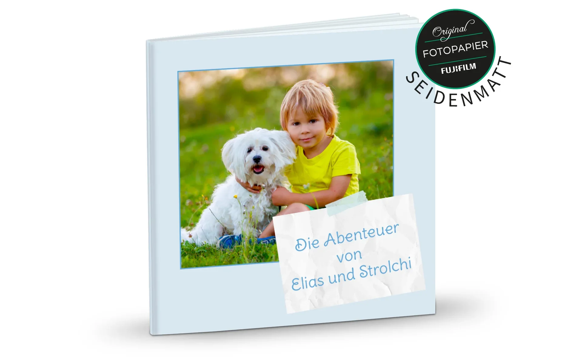 Ein aufgestelltes Happy Fotobuch ca. 13 x 13 cm mit dem Titel Die Abenteuer von Elias und Strolchi zeigt einen Jungen mit einem Hund.